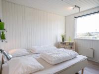 two beds in a white room with a window at Holiday home Hvide Sande LXIX in Havrvig