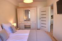Posteľ alebo postele v izbe v ubytovaní Apartamenty KORAL
