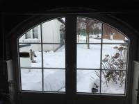 a window with a view of a snow covered yard at De Witte Molen Kranenburg in Kranenburg