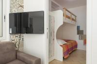 Televízia a/alebo spoločenská miestnosť v ubytovaní Appartamento Gardenia in Villa Mariella