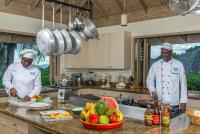 モンテゴ・ベイにあるSilent Waters Villaのキッチンに立って料理を準備する2人のシェフ