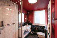 a bathroom with a sink and a toilet and a window at Hotel Haverkamp in Bremerhaven