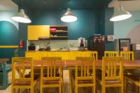a dining room with a wooden table and chairs at Wonderloft Hostel Kota Tua in Jakarta