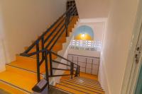 a staircase in a house with wooden floors and a staircase at Wonderloft Hostel Kota Tua in Jakarta