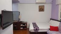 a small bedroom with a bed and a tv at Dongshan River Left Bank in Wujie