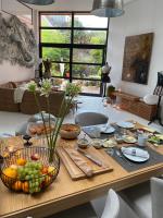 a table with a bunch of food on it at Chambre d&#39;hôtes la Teinturerie in Roubaix