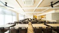 an empty dining room with tables and chairs at Hotel Torifito Miyakojima Resort in Miyako Island