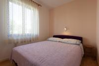 Postel nebo postele na pokoji v ubytování Apartments Nedeljka