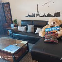 a teddy bear sitting on a couch in a living room at 伊家民宿Yi home 志航路一段398號 in Taitung City