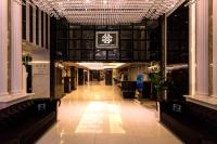 a lobby with a sign on the ceiling in a building at Harmonious Hotel in Kaohsiung