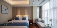 Postel nebo postele na pokoji v ubytování Yushan Town Tianji Cloud Business Hotel