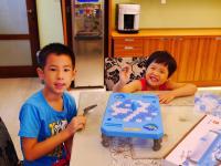 two young boys sitting at a table with a toy at Jane Castle in Wujie