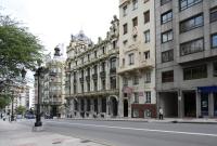 a street with tall buildings on a city street at Santacruz in Oviedo