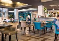 a restaurant with tables and chairs and a bar at The West Park Hotel in Harrogate