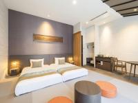 a bedroom with a large white bed and a table at Tokyu Stay Kyoto Sanjo-Karasuma in Kyoto