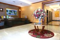 a lobby with a vase of flowers on a table at Fushin Hotel - Tainan in Tainan