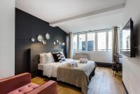 a bedroom with a bed and a large window at CMG - Champs Elysées Boetie 4DF in Paris