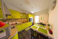 a kitchen with bright yellow cabinets and a kitchen island at Entre parc et Haras in Hennebont