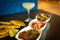 a table with three dishes of food and a glass of wine at Cambria Hotel Downtown Asheville in Asheville