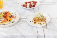 three plates of food on a white table at Kimpton Everly Hotel Hollywood by IHG in Los Angeles