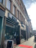 a gin store on a street in a city at Hotel Guzy in Lier