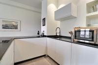 a kitchen with white cabinets and a microwave at Appartement entier - refait à neuf - Loft - City Center in Lyon