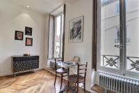 a room with a table and chairs and a window at Appartement entier - refait à neuf - Loft - City Center in Lyon