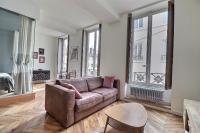 a living room with a couch and a table at Appartement entier - refait à neuf - Loft - City Center in Lyon
