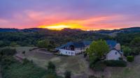 an aerial view of a house on a hill with a sunset at Domaine Leyvinie, gite Mourvedre, close to the Dordogne in Perpezac-le-Blanc