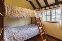 a bedroom with a bunk bed and a window at Domaine Leyvinie, gite Mourvedre, close to the Dordogne in Perpezac-le-Blanc