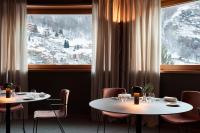 a restaurant with two tables and a large window at Hotel Tremoggia in Chiesa in Valmalenco