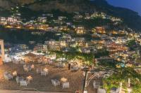 a view of a city at night at Hotel Poseidon in Positano