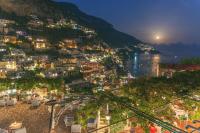 a view of a city at night with a river at Hotel Poseidon in Positano