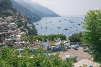 a view of a city with boats in the water at Hotel Poseidon in Positano