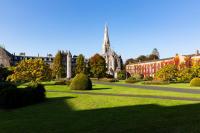 a park in front of a building with a church at Maynooth Campus Accommodation in Maynooth