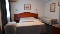 Łóżko lub łóżka w pokoju w obiekcie Hotel Tortorina