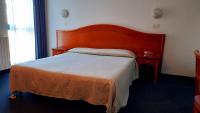 Łóżko lub łóżka w pokoju w obiekcie Hotel Tortorina