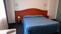 Łóżko lub łóżka w pokoju w obiekcie Hotel Tortorina