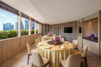 a conference room with tables and chairs and a tv at PARKROYAL COLLECTION Marina Bay, Singapore in Singapore