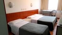 Łóżko lub łóżka w pokoju w obiekcie Hotel Tortorina