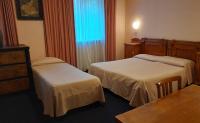 Łóżko lub łóżka w pokoju w obiekcie Hotel Tortorina