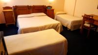 Łóżko lub łóżka w pokoju w obiekcie Hotel Tortorina