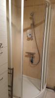 a shower with a glass door in a bathroom at 24 rue St Exupery in Gap