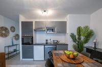 a kitchen with a table with a bowl of fruit on it at Voltaire in Toulouse