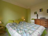 a green bedroom with a bed and a dresser at Holiday Home with Garden Heating Barbecue in Butgenbach