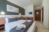 Łóżko lub łóżka w pokoju w obiekcie Hotel Airone