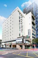 a large white building with a parking lot in front of it at Dandy Hotel-Daan Park Branch in Taipei