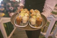 a person holding a tray of food and drinks at Hotel Kollol by J&Z Group in Cox's Bazar