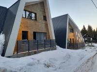 a house in the snow in front at Olympic Oasis in Jahorina