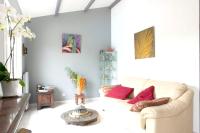 a living room with a white couch and red pillows at Villa de 4 chambres avec piscine privee jardin clos et wifi a Aytre a 5 km de la plage in Aytré
